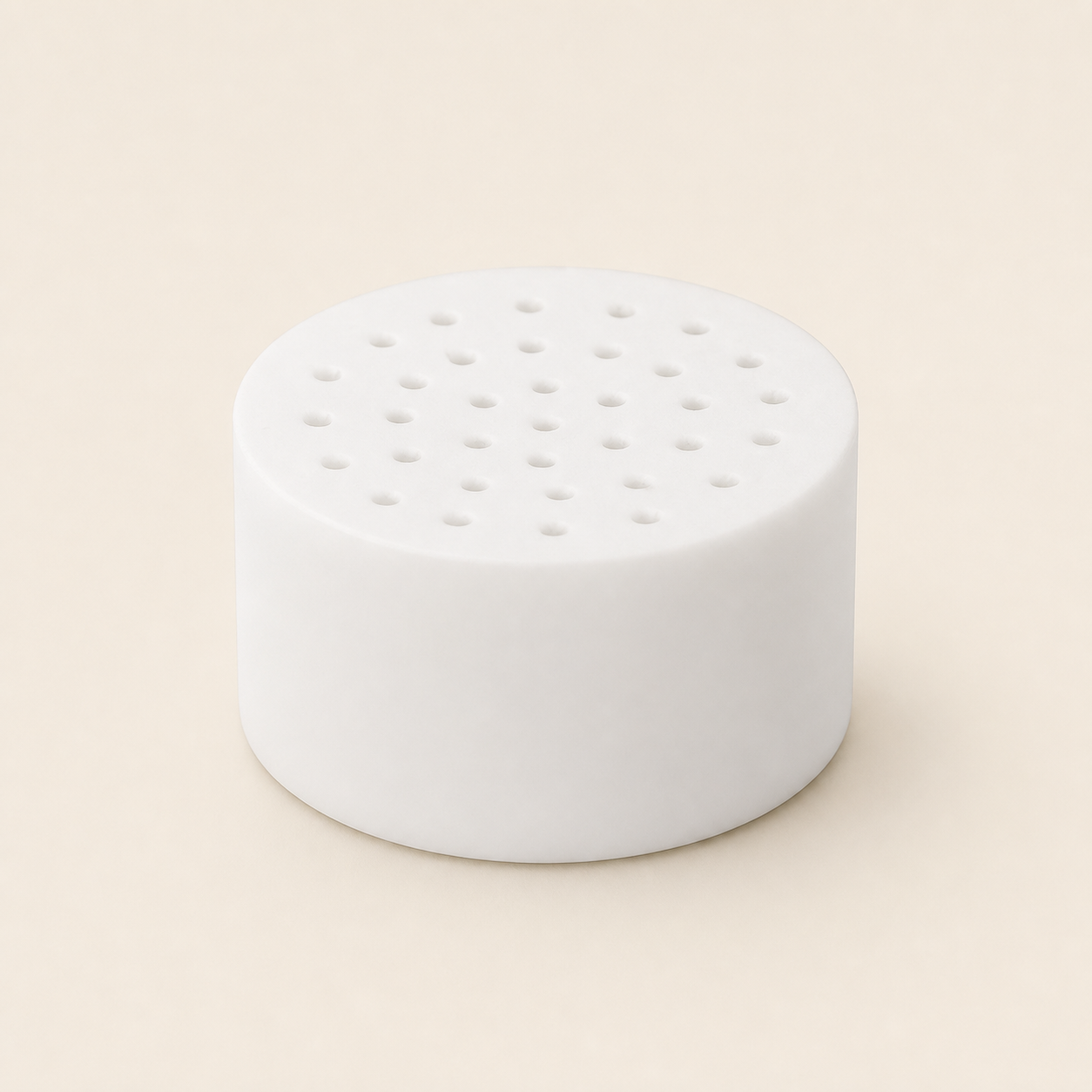 Single white CL-SF1 replacement shower filter cartridge on a warm eggshell background