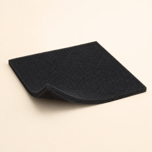 Black cut-to-fit activated-carbon pre-filter sheet with a trimmed sample on a warm eggshell background